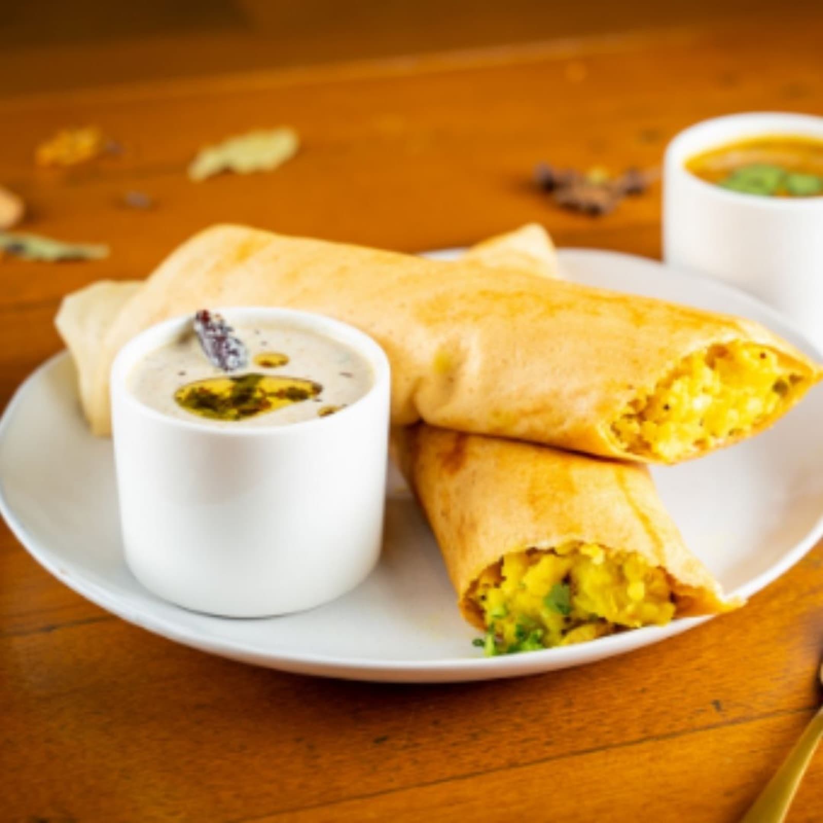 Crisp masala dosa served with a plate of accompaniments